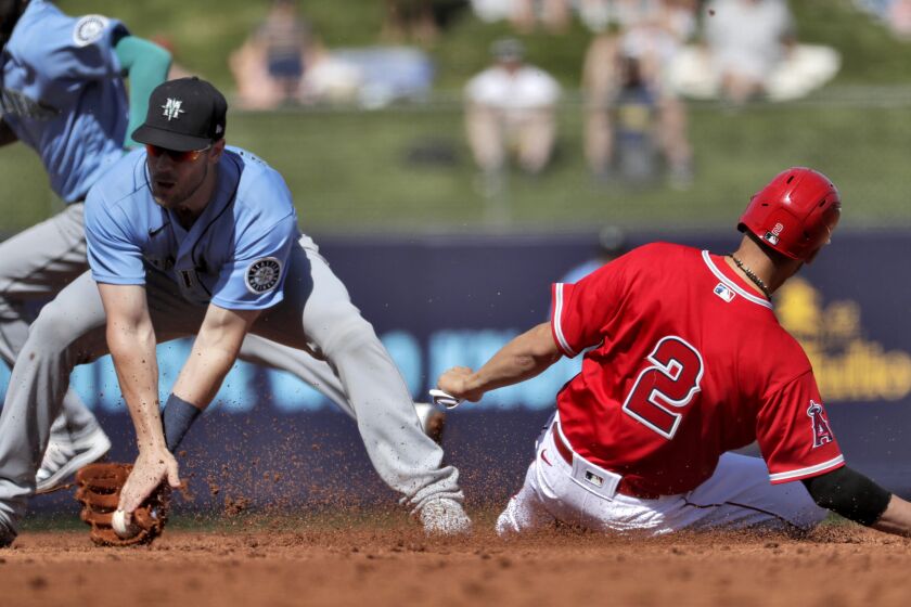 Los Angeles Angels' Andrelton Simmons (2) steals second base as Seattle Mariners' Patrick Wisdom catches the late throw during the second inning of a spring training baseball game Wednesday, March 4, 2020, in Tempe, Ariz. (AP Photo/Matt York)