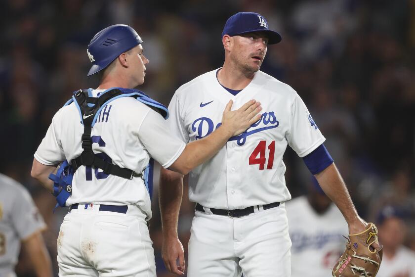 Daniel Hudson, right, and Will Smith celebrate the Dodgers' 6-4 victory against the Pittsburgh Pirates on July 5, 2023.