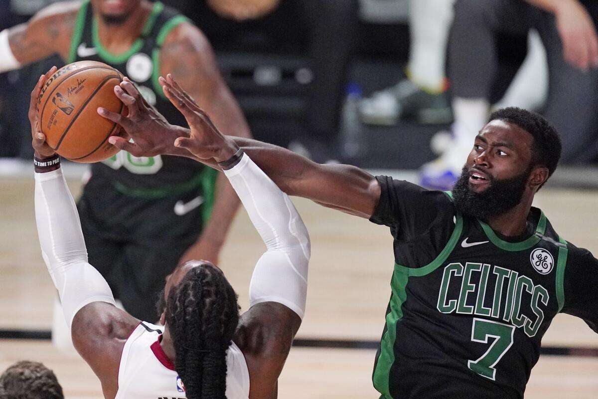 Boston guard Jaylen Brown blocks Miami forward Jae Crowder.