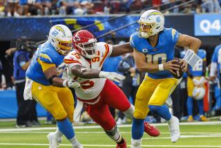 Chris Jones (95) chases Justin Herbert as the Chiefs tackle is being held by center Sam Mustipher.