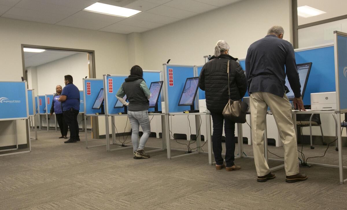 Voters cast ballots in San Diego on Super Tuesday. Washington state, which will hold its primary next week, is asking voters to not lick the envelopes used for mail-in ballots.