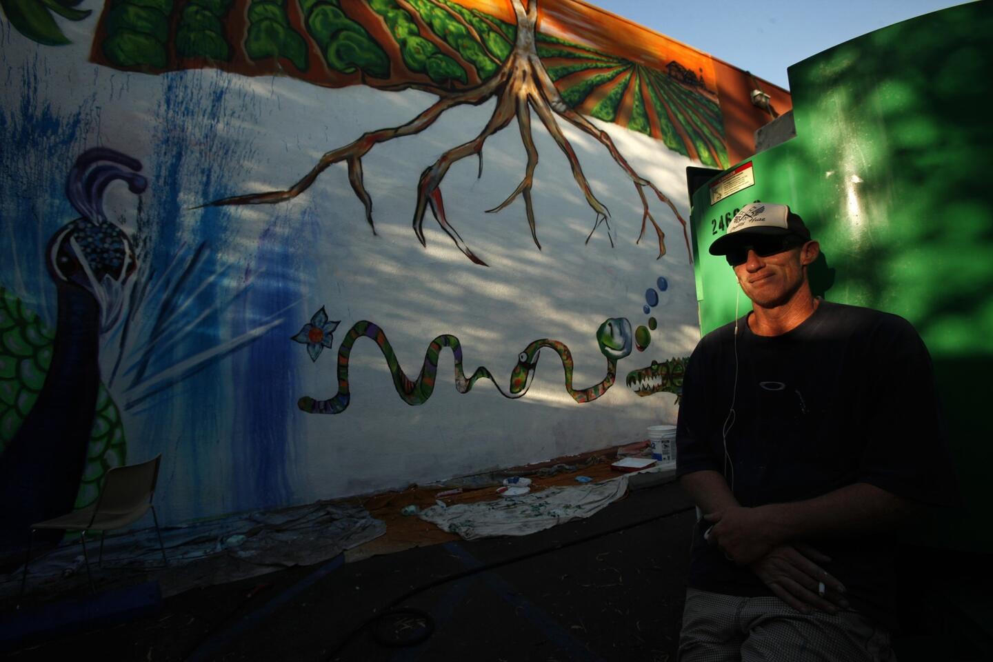 Former USC Trojan and Los Angeles Raider Todd Marinovich in 2014 in Garden Grove, where he was painting a mural on the side of the Gem Theater.