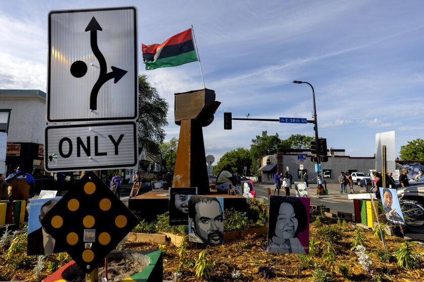 A traffic sign signals directions around the monument at George Floyd Square, Thursday, June 3, 2021, in Minneapolis. Crews are removing concrete barriers as well as artwork, flowers and other memorial items from a Minneapolis intersection that has become a sprawling memorial to George Floyd. (Crews are removing concrete barriers as well as artwork, flowers and other memorial items from a Minneapolis intersection that has become a sprawling memorial to George Floyd. (Carlos Gonzalez/Star Tribune via AP)
