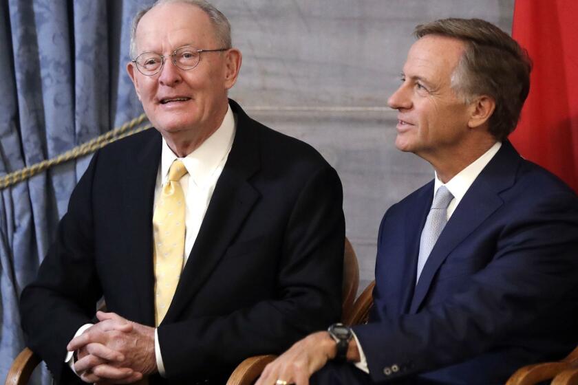 U.S> Sen. Lamar Alexander, R-Tenn., left, sits with outgoing Tennessee Gov. Bill Haslam during a ceremony unveiling Haslam's official portrait Monday, Dec. 17, 2018, in Nashville, Tenn. Alexander announced Monday he is not running for re-election in 2020. (AP Photo/Mark Humphrey)