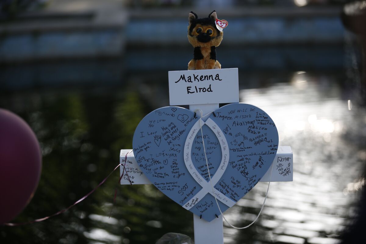 Makenna Elrod's cross stands at a memorial site for the victims killed in this week's shooting at Robb Elementary School in Uvalde, Texas, Friday, May 27, 2022. (AP Photo/Dario Lopez-Mills)