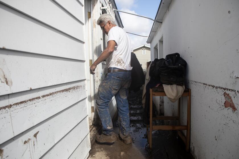 San Diego, CA - January 23: Greg Montoya, 68, heads inside his home to clean after heavy rain Monday caused flooding near Birch and Una Streets in Southcrest on Jan. 23, 2024 in San Diego, California. Montoya was part of a lawsuit against the City that was filed in 2019 after other flooding issues. Montoya said he emailed the City last week telling them that storm drains were clogged and needed to be cleaned.