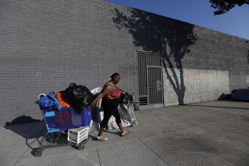 LOS ANGELES, CA May 3, 2018: Leneace Pope known as ÒNiecy,Ó moves one block away from her neighbors Top Shelf and Big Mama in a small homeless encampment on Broadway Place in Los Angeles, CA May 3, 2018. (*Editors Note: Contact photo editor Mary Cooney should you have any questions. Please do not use this image for other stories. This image is for a future project by writer Tom Curwen.) (Francine Orr/ Los Angeles Times)