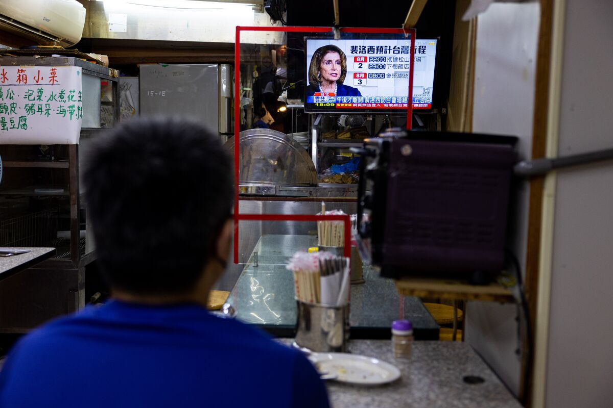 Nancy Pelosi appears on a TV screen inside a restaurant in Taipei, Taiwan. 