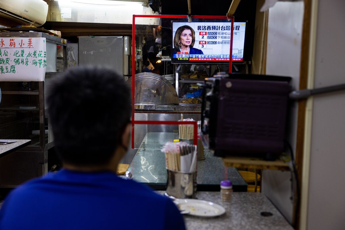 Nancy Pelosi appears on a TV screen inside a restaurant in Taipei, Taiwan.