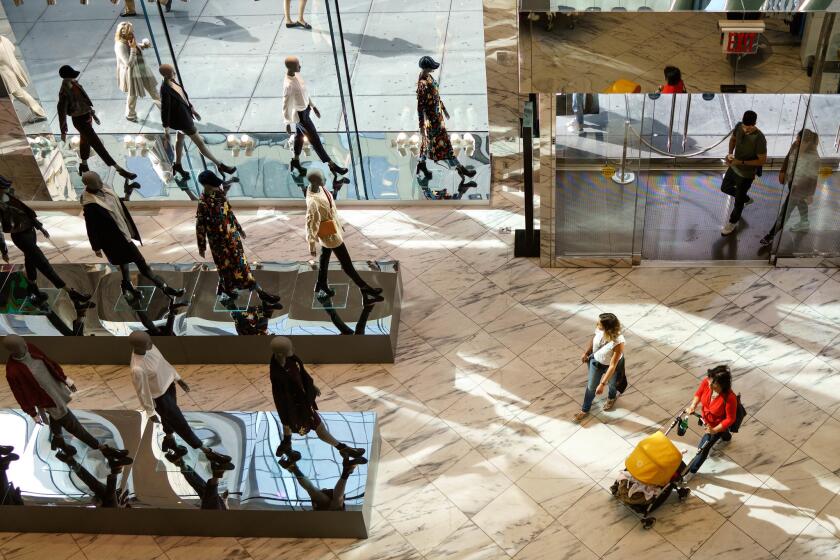 Shoppers walk into an H&M clothing store on Fifth Avenue in New York City on Sept. 27.