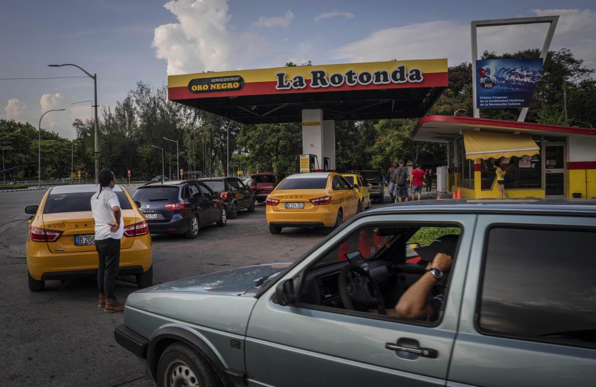 Drivers wait their turn to fuel their vehicles at a gas station in Havana, Cuba, Thursday, July 14, 2022. (AP Photo/Ramon Espinosa)