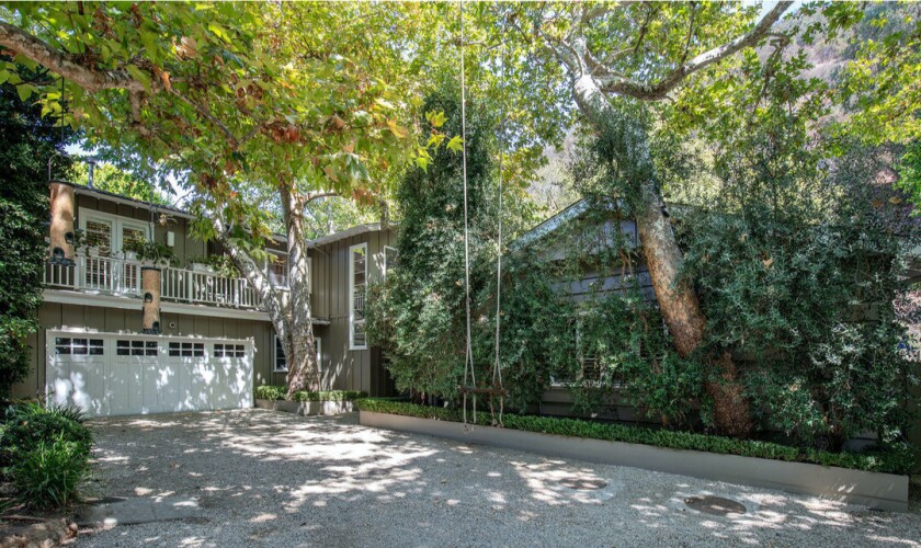 Surrounded by sycamore trees, the leafy residence centers on a five-bedroom traditional built in the 1950s.