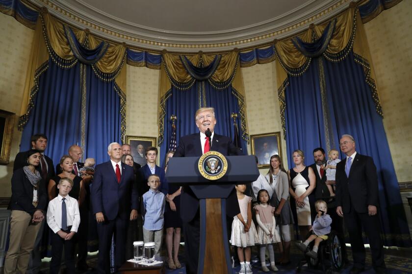 In this July 24, 2017, file photo, President Donald Trump, accompanied by Vice President Mike Pence, Health and Human Services Secretary Tom Price, and others, speaks about healthcare, in the Blue Room of the White House in Washington. A study by a nonpartisan group says the Trump administration's own actions are triggering double-digit premium increases on individual health insurance policies purchased by millions of consumers.