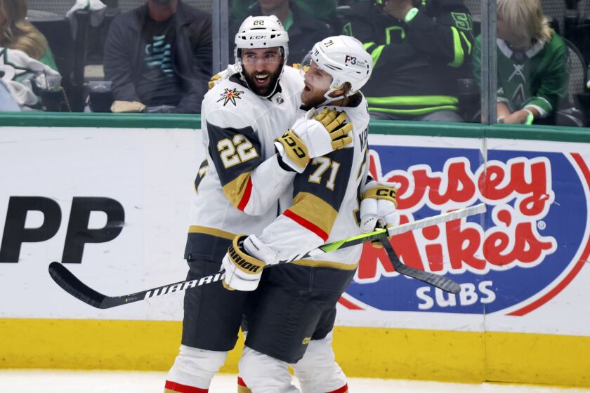 Vegas Golden Knights center William Karlsson (71) celebrates with right wing Michael Amadio (22) after Karlsson's goal during the third period of Game 6 of the NHL hockey Stanley Cup Western Conference finals against the Dallas Stars, Monday, May 29, 2023, in Dallas. (AP Photo/Gareth Patterson)