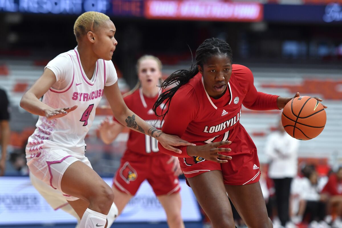 Louisville forward Olivia Cochran, right, is defended by Syracuse forward Alaysia Styles during the first half of an NCAA college basketball game in Syracuse, N.Y., Sunday, Feb. 6, 2022. (AP Photo/Adrian Kraus)