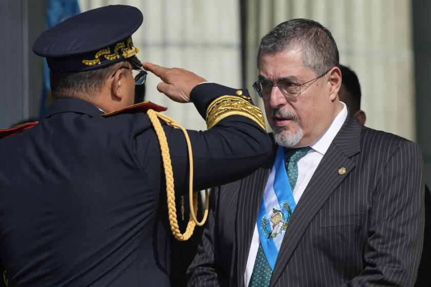 Army Gen. Henry Saenz salutes President Bernardo Arévalo to recognize him as the army's commander and chief during a ceremony at Constitution square in Guatemala City, Monday, Jan. 15, 2024, the morning after his inauguration. (AP Photo/Moises Castillo)