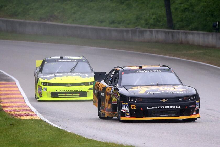 NASCAR driver Brendan Gaughan guides his No. 62 Chevrolet through some curves ahead of Justin Marks in the Nationwide Series Gardner Denver 200 at Road America in Elkhart Lake, Wis.