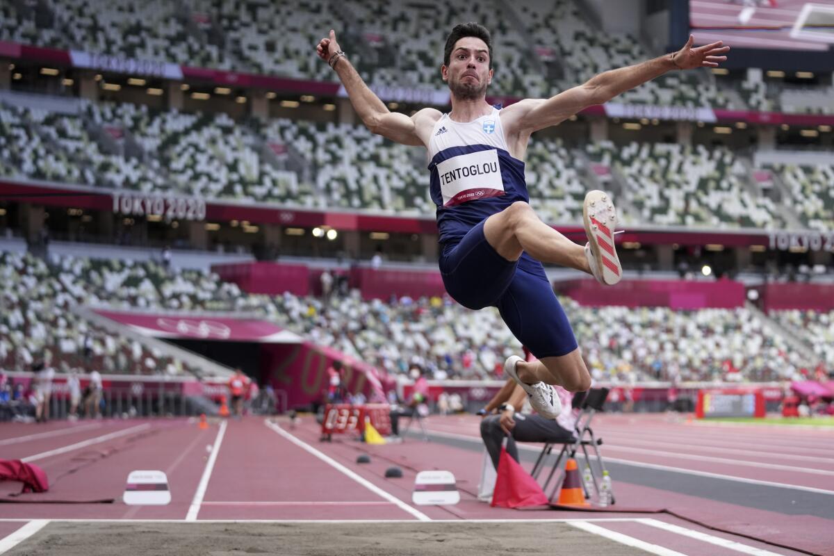Greece's Miltiadis Tentoglou is in midair as he competes in men's long jump.