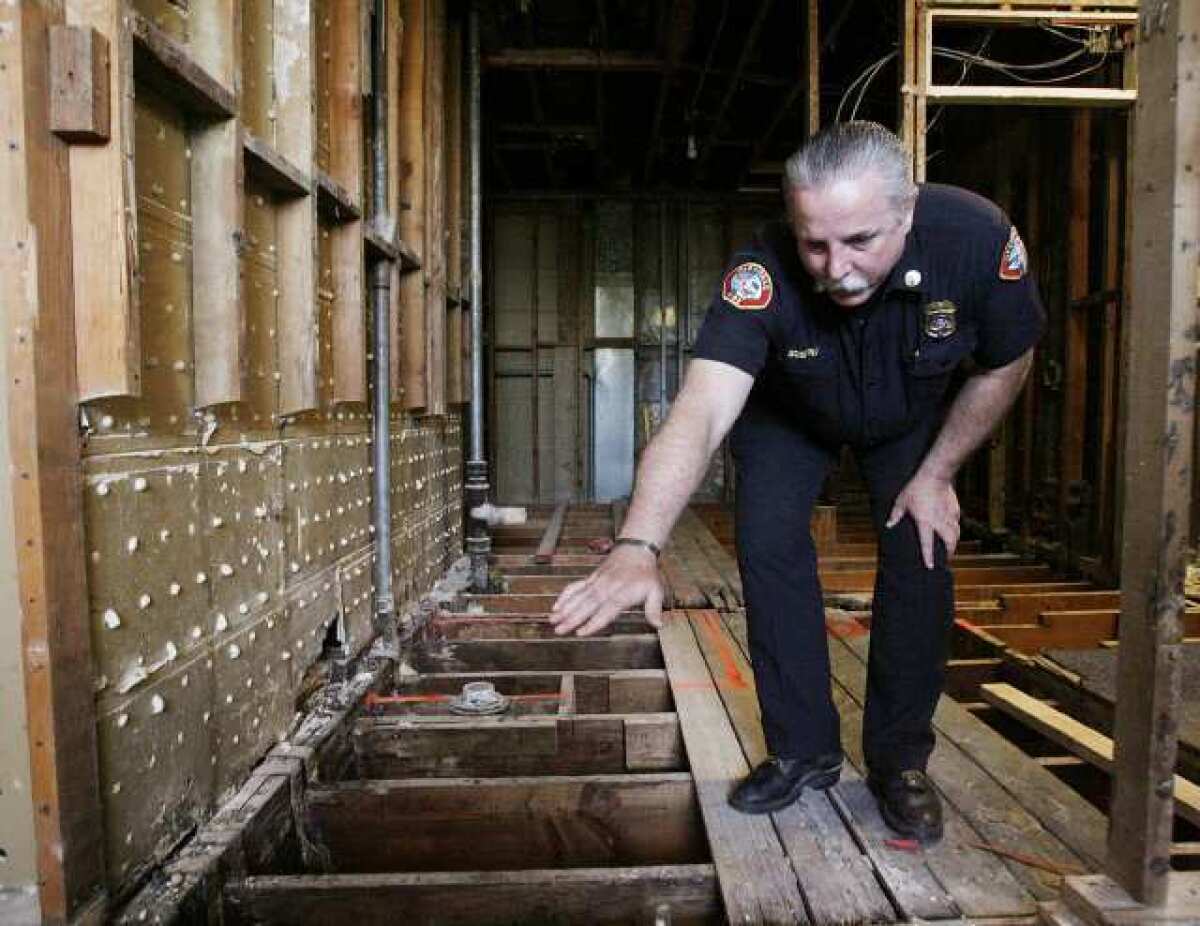 Battalion Chief Greg Godfrey of the Glendale Fire Department shows where the flooring of the shower room was in pretty bad shape and in need of repair at Fire Station 26 in Glendale. The room Chief Godfrey is in will eventually be three bathrooms. The station, which shares the building with the Glendale Public Library, is being updated for $300,000.