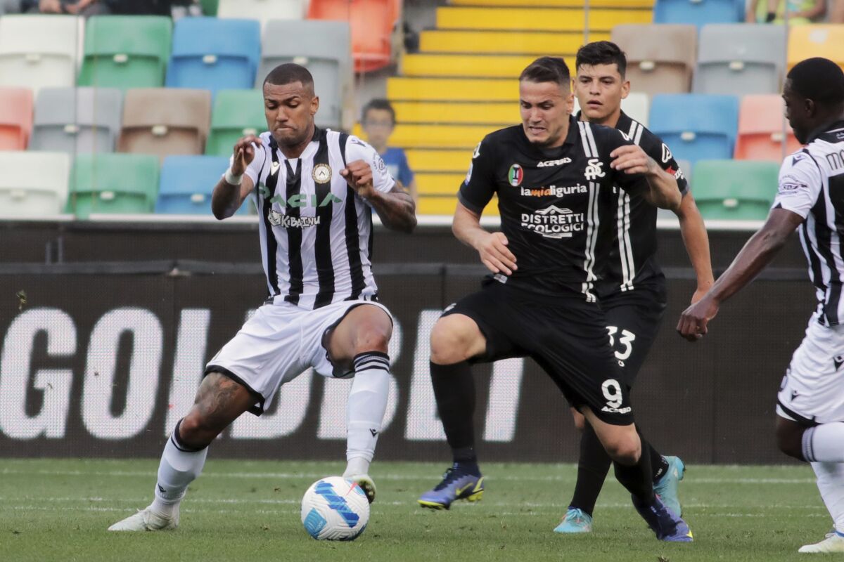 Spezia's Rey Manaj and Udinese's Walace, left, battle for the ball during the Serie A soccer match between Udinese and Spezia at Friuli Stadium, Udine, Italy, Sunday May 14, 2022. (Andrea Bressanutti/LaPresse via AP)