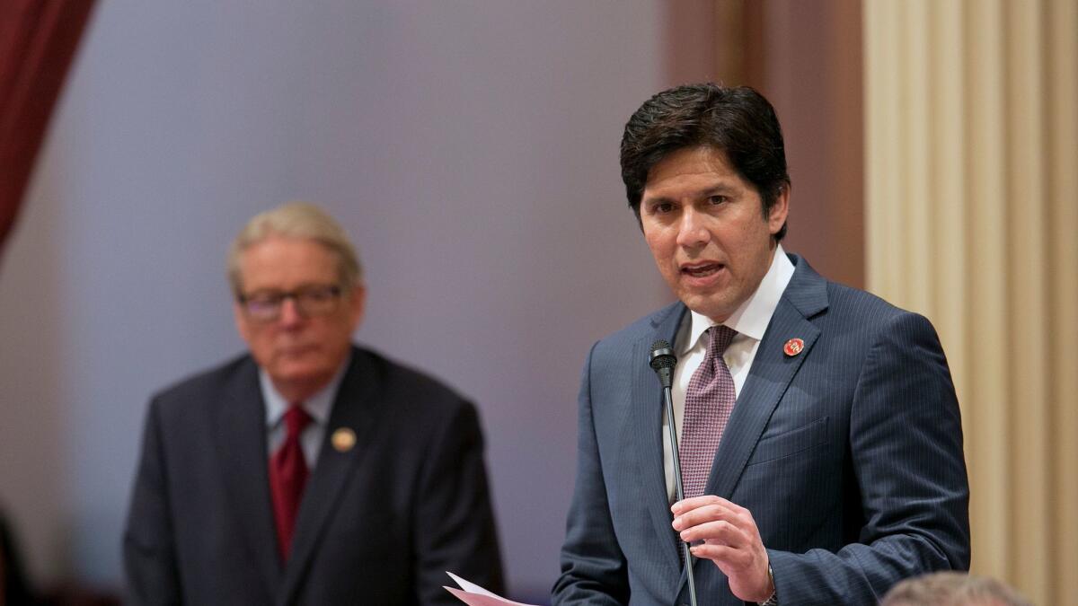 State Senate President Pro Tem Kevin de León (D-Los Angeles), right, speaks during the last regular Senate floor session of the year Sept. 15 as Sen. Bill Monning (D-Carmel) looks on.