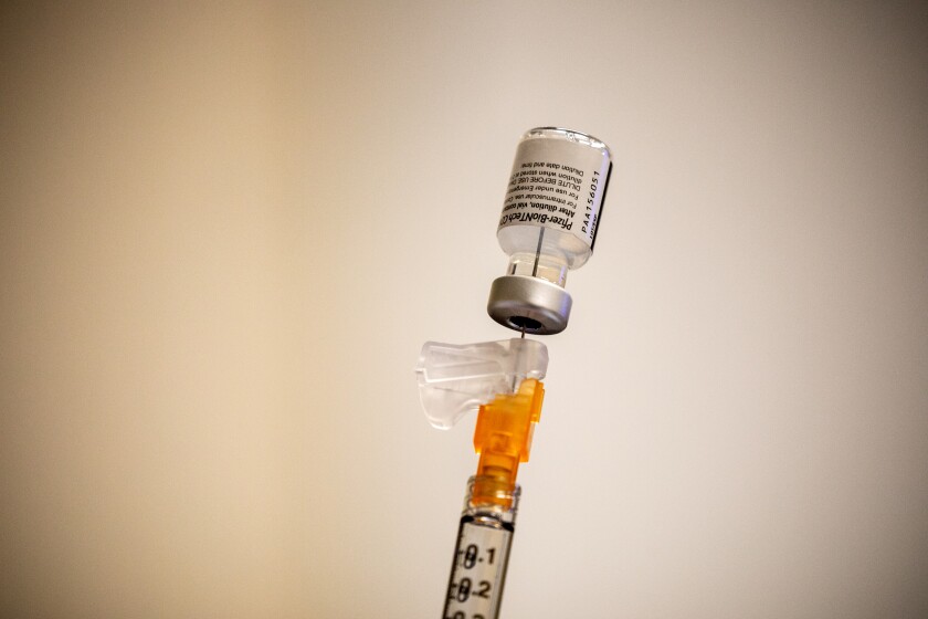 A syringe filled with COVID-19 vaccine.