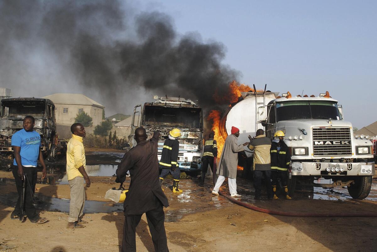 Firefighters try to contain a blaze following a suicide attack on oil tankers in Maiduguri, Nigeria, on March 3.
