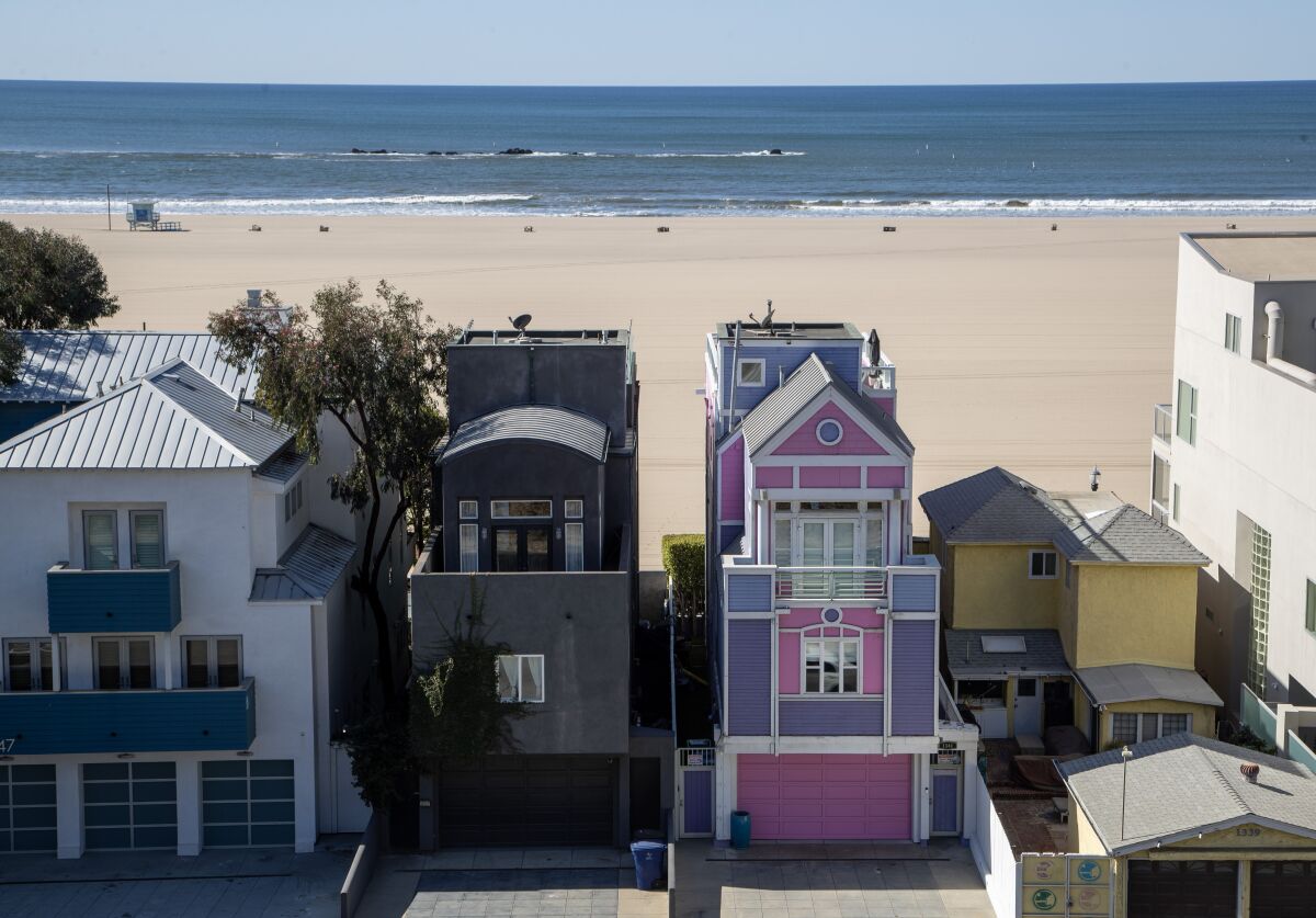 Black house, left, and pink and purple house, right