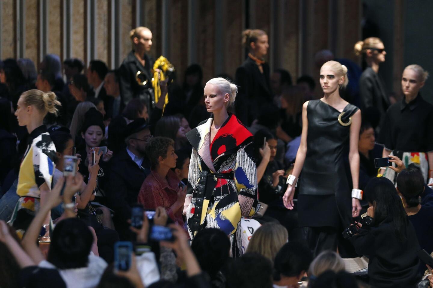 Models present pieces from Celine's spring/summer 2014 collection during Paris Fashion Week.