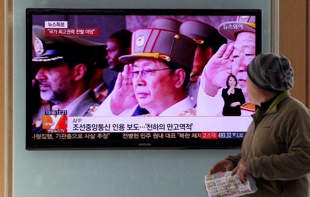 A South Korean man watches TV news showing North Korean politician Jang Song Taek, reportedly executed and labeled a traitor.