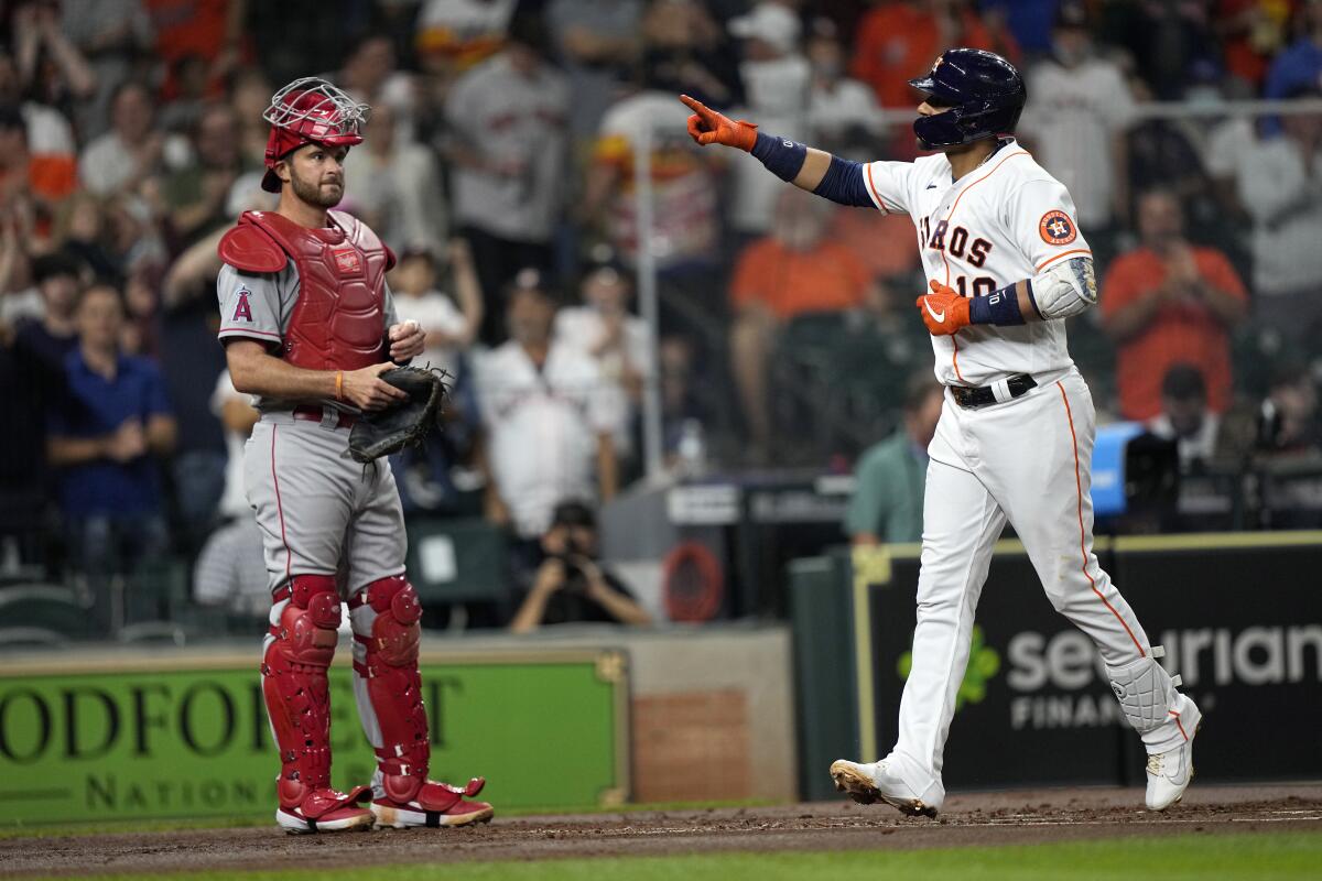 Houston's Yuli Gurriel celebrates as he crosses the plate in front of Angels catcher Drew Butera after hitting a home run.