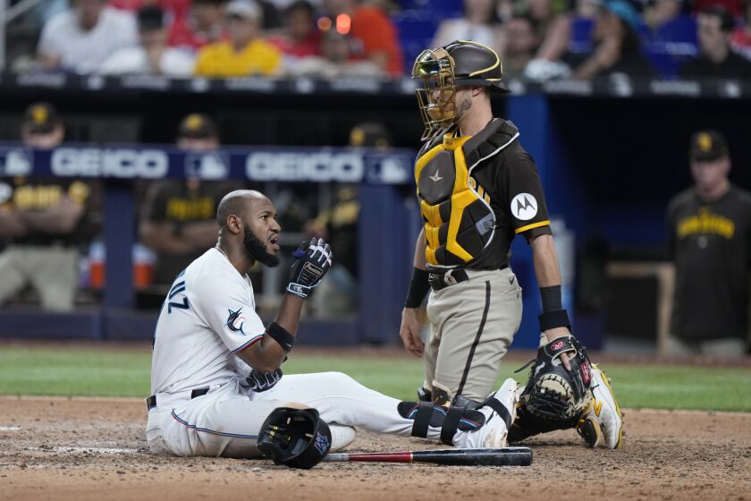Miami Marlins' Bryan De La Cruz reacts after avoiding a close pitch during the eighth inning of a baseball game against the San Diego Padres, Tuesday, May 30, 2023, in Miami. (AP Photo/Wilfredo Lee)