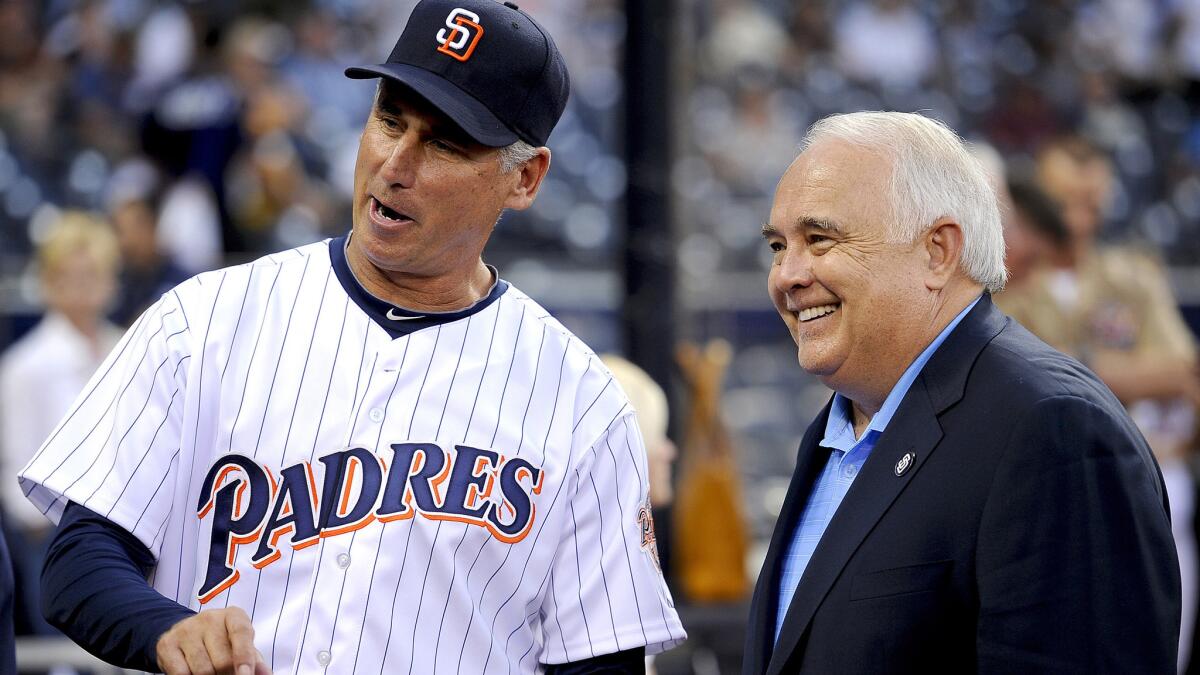 Ron Fowler, executive chairman of the San Diego Padres, chats with former manager Bud Black during a game in 2012.