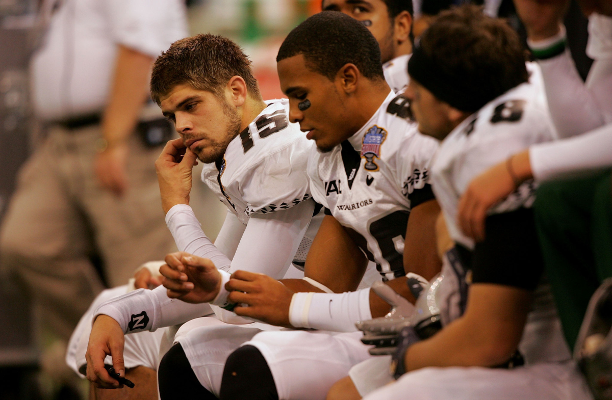 Colt Brennan sits on the bench with teammates during a loss to Georgia in the 2008 Sugar Bowl in New Orleans.
