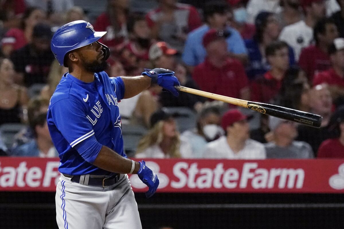 Toronto Blue Jays' Teoscar Hernandez watches his three-run home run during the fifth inning of the team's baseball game against the Los Angeles Angels on Wednesday, Aug. 11, 2021, in Anaheim, Calif. (AP Photo/Marcio Jose Sanchez)