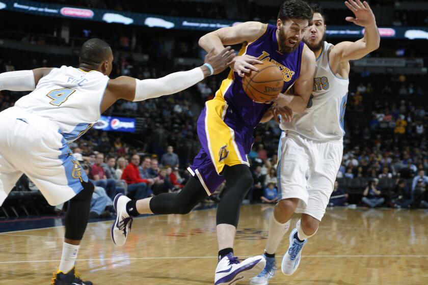 Laker Ryan Kelly, center, tries to get past Denver's Danilo Gallinari, right. The Lakers will play the Sacramento Kings on Monday night.