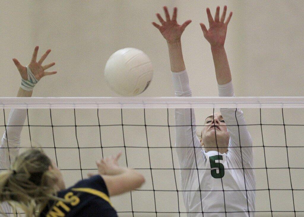 Sage Hill School's Juliette Singarella (5) blocks Crean Lutheran's Katie Kyckelhahn, left, during the third set in a CIF State Southern California Regional Division III semifinal match on Saturday.