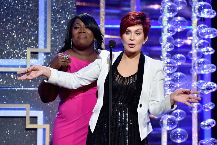 TV personality Sheryl Underwood watches and listens as Sharon Osbourne lets a few f-bombs fly.
