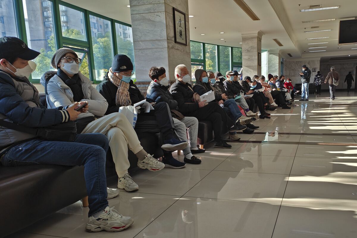 Family members of the deceased wait for the cremation procedures at a funeral home in Shanghai on Jan. 4, 2023. 