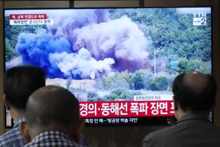 A TV screen reports North Korea has blown up parts of northern side of inter-Korean roads during a news program at Seoul Railway Station in Seoul, South Korea, Tuesday, Oct. 15, 2024. (AP Photo/Ahn Young-joon)