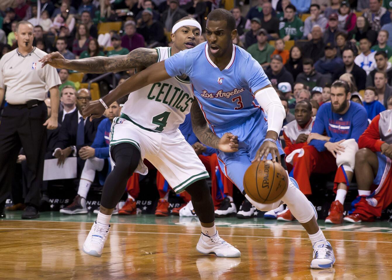 Clippers point guard Chris Paul drives against Celtics point guard Isaiah Thomas in the first half Sunday.