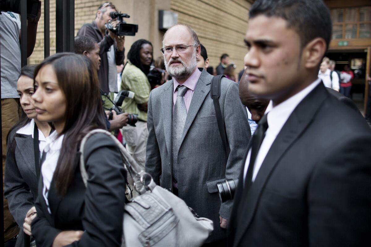 Forensic geologist Roger Dixon, center, leaves court in Pretoria, South Africa, after testifying in the trial of Olympic athlete Oscar Pistorius.