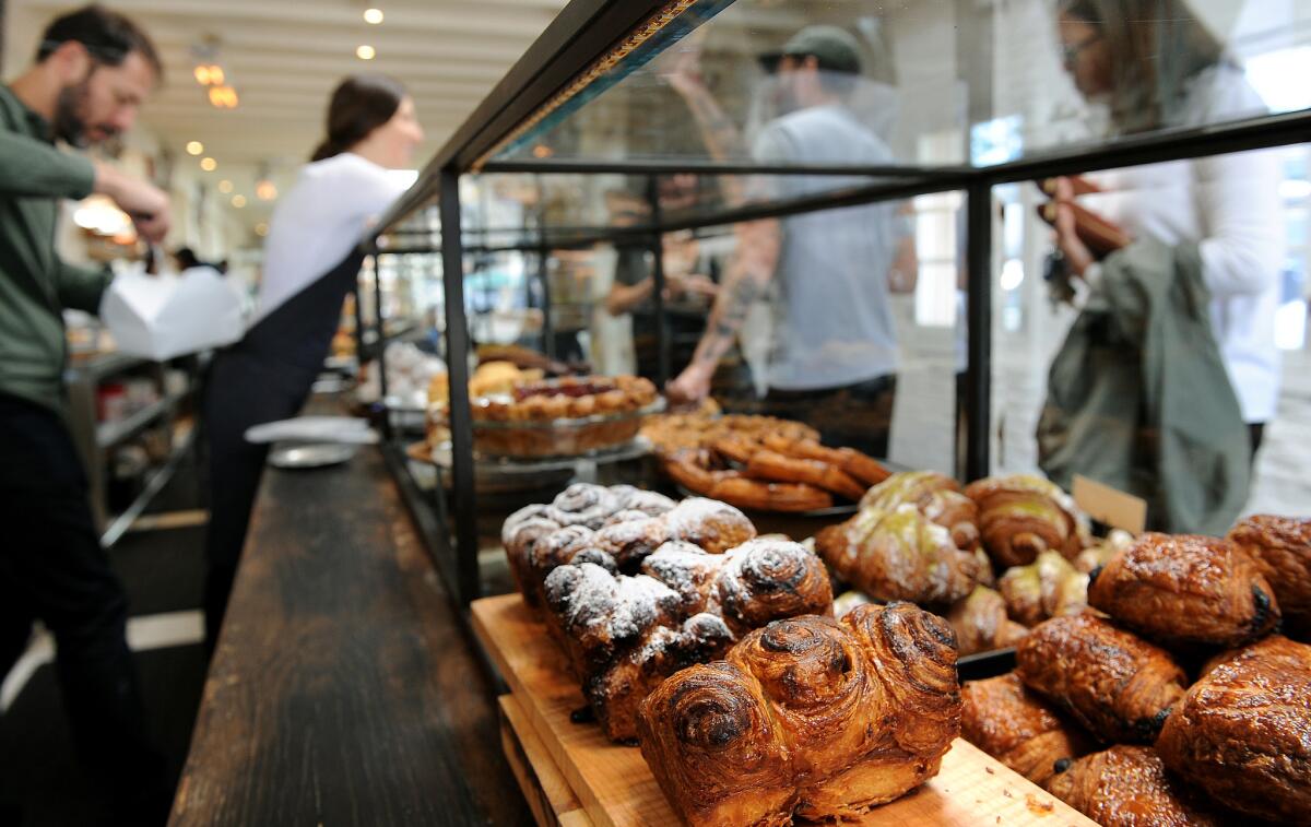 Customers check out baked goods in the display case at Gjusta Bakery in Venice.
