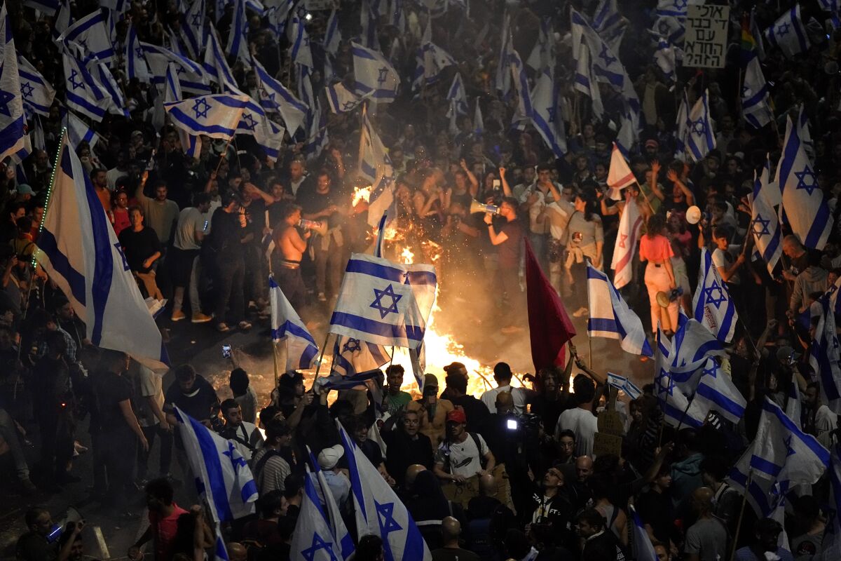 Israelis opposed to Prime Minister Benjamin Netanyahu set bonfires and block a highway in Tel Aviv on Sunday.