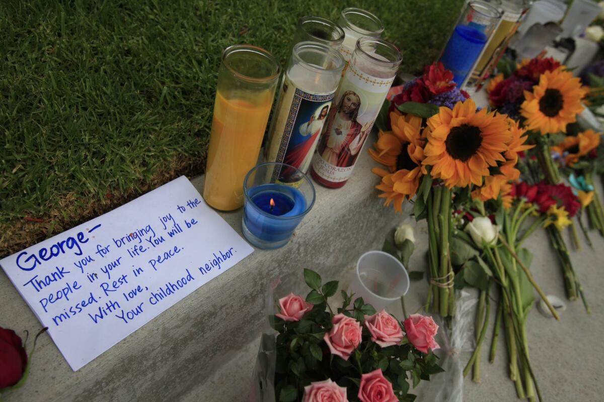 Flowers have been placed outside the apartment where Elliot Rodger lived and allegedly stabbed three victims to death in Isla Vista, Calif. The note is presumably written for George Chen, 19, one of the stabbing victims.
