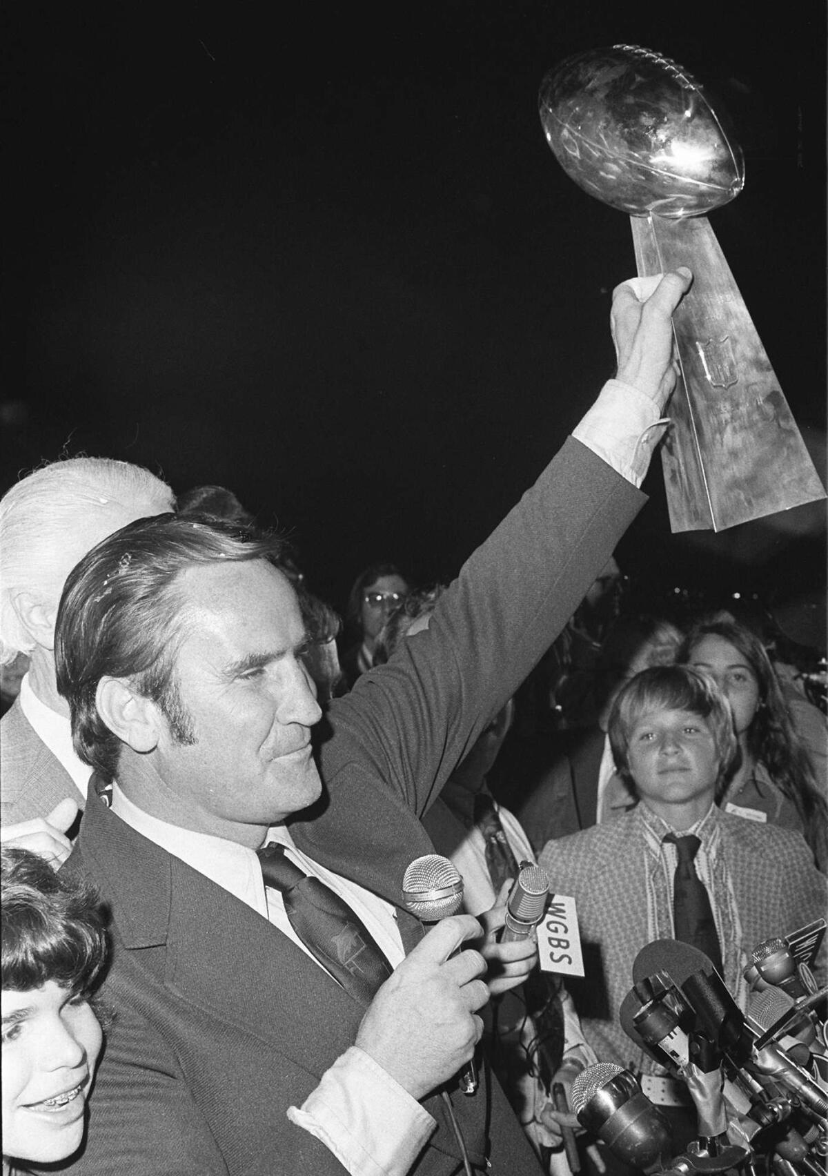 Miami coach Don Shula waves the Lombardi trophy for fans after arriving in Miami following Super Bowl VII.