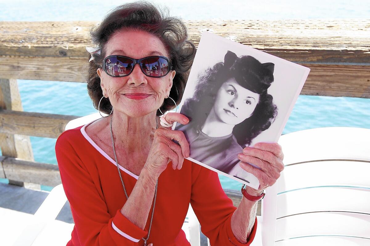 Ruby Cavanaugh, whose son named the Ruby's Diner chain after her, holds a photo of herself as a young woman.