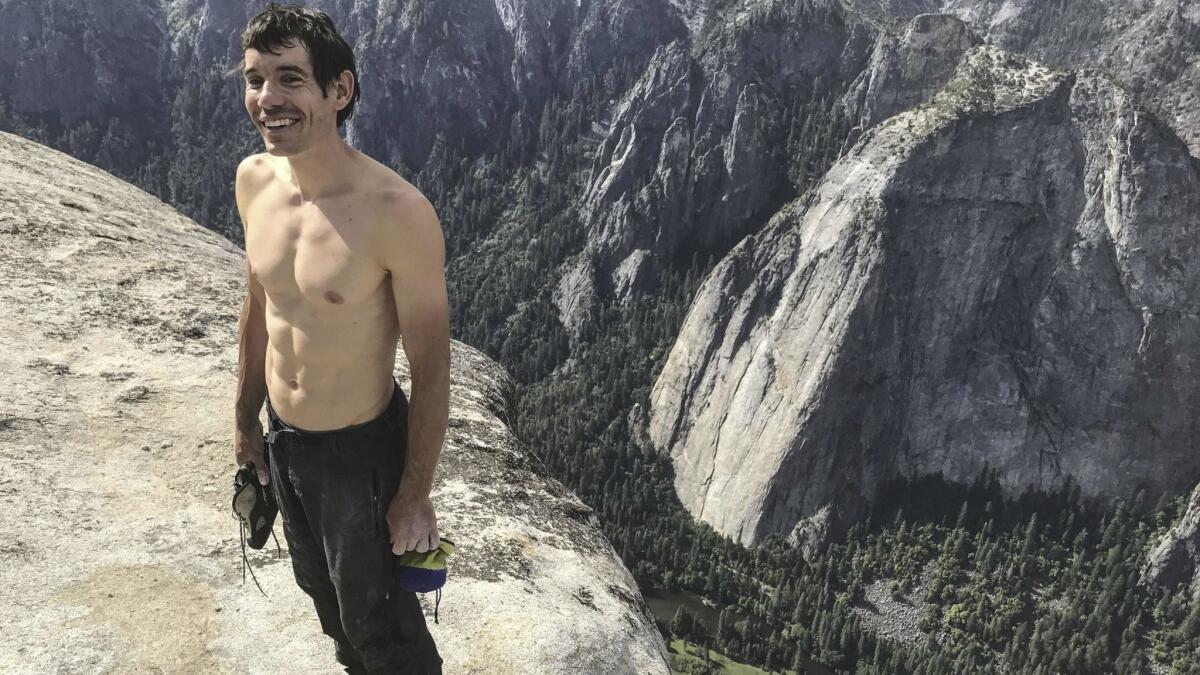 Alex Honnold as he holds all of his climbing gear atop the summit of El Capitan,in Yosemite National Park.