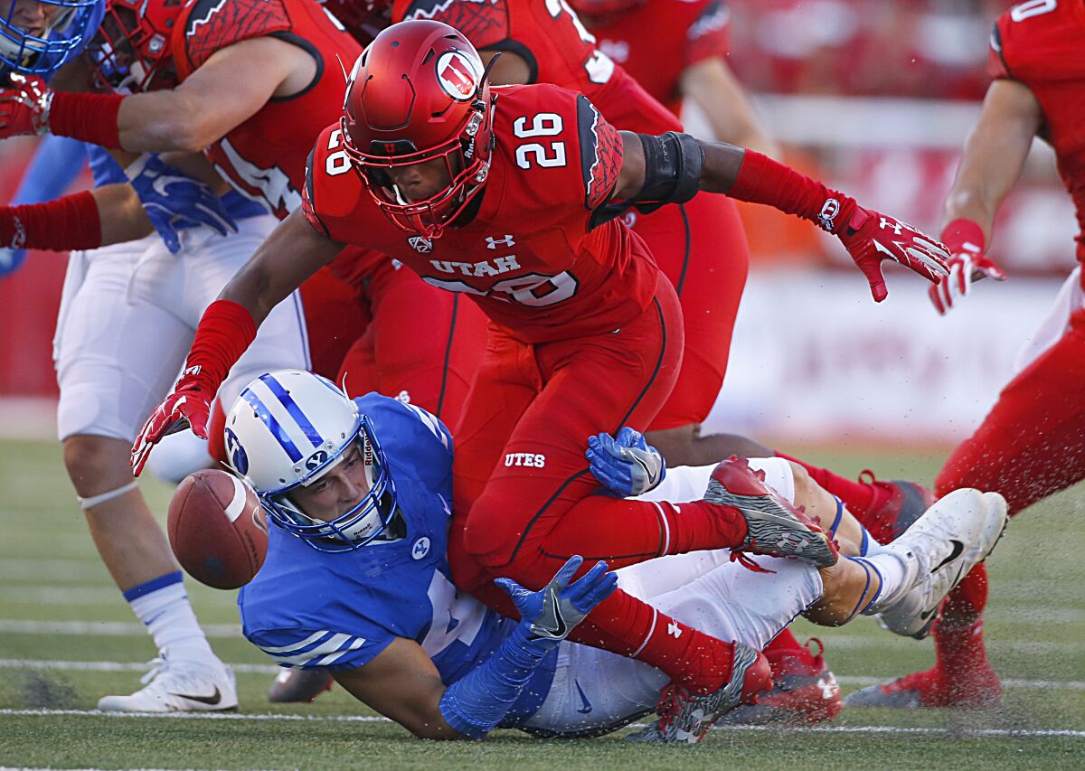 Utah product Terrell Burgess (26) pursues a loose ball against Brigham Young.