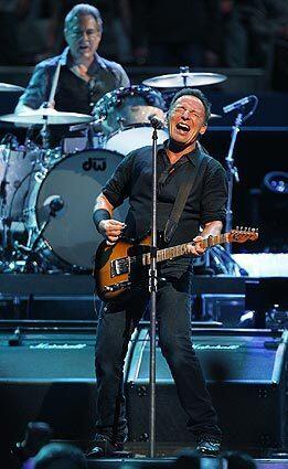 Bruce Springsteen and the E Street Band powered through 26 songs Thursday night at the Los Angeles Memorial Sports Arena. Behind Springsteen is drummer Max Weinberg.